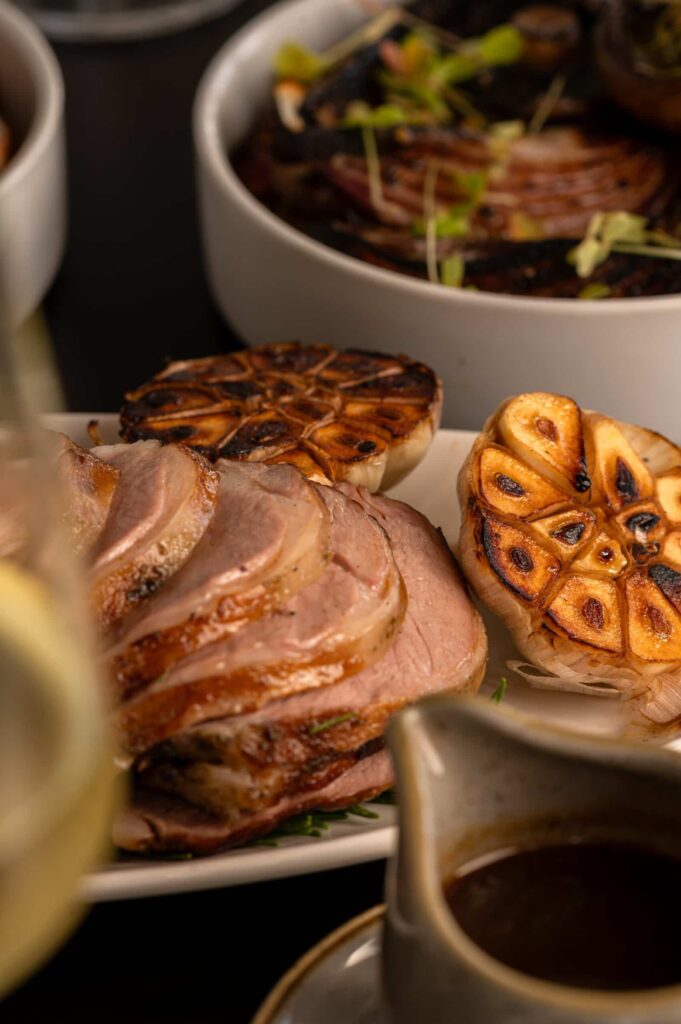 Savour succulent roasted meats and grilled garlic at Palm House Boutique Hotel and Spa, renowned for luxurious accommodations and gourmet dining experiences in South Africa.