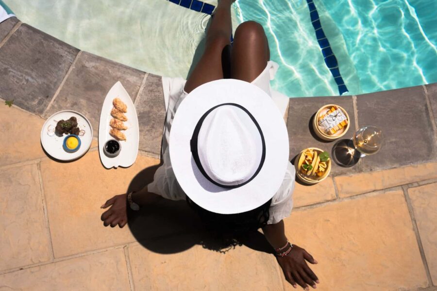 Luxurious poolside dining experience at Palm House Boutique Hotel and Spa, featuring gourmet dishes, refreshing drinks, and elegant relaxation by the pool in Stellenbosch, South Africa.