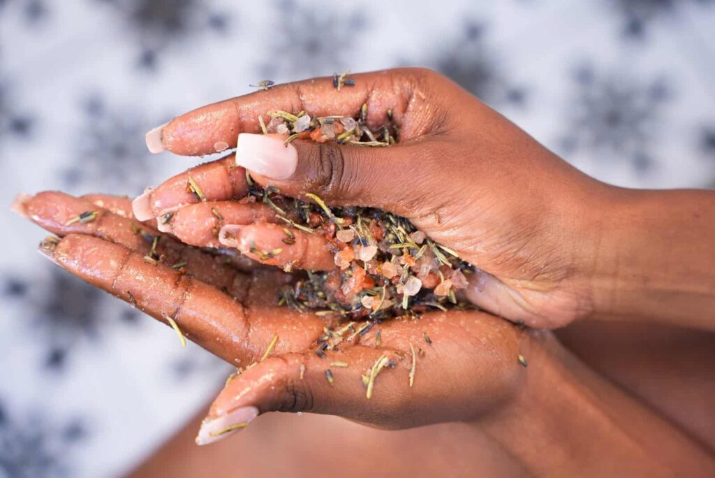 Freshly harvested herbal bath salts with natural salts, dried herbs, and flower petals for relaxation and wellness.