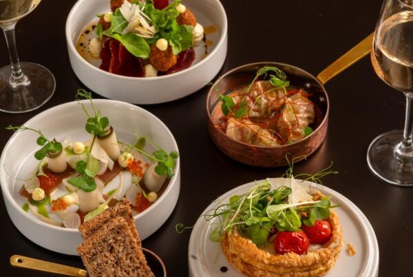 Elegant gourmet dishes served on black table at Palm House Boutique Hotel and Spa, showcasing fine dining experience inspired by The Spice Route Experience.